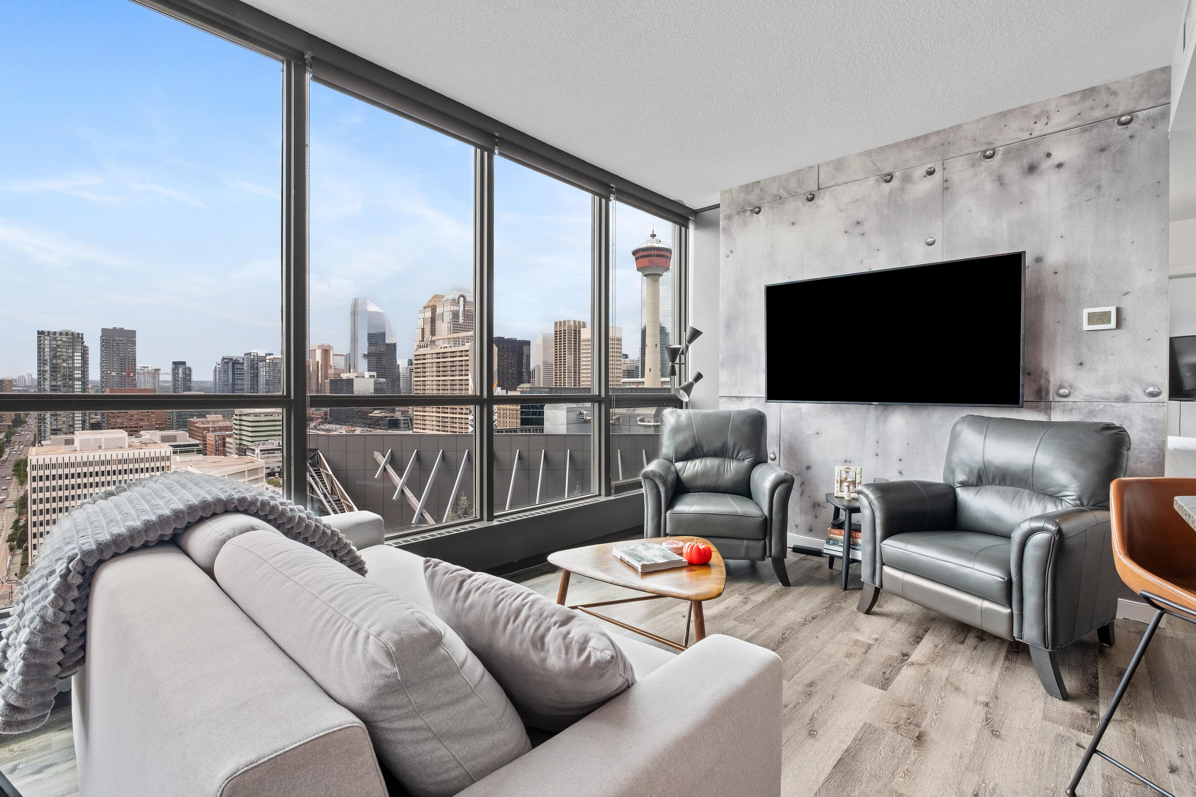 Downtown Calgary condo living room with floor-to-ceiling windows and a Calgary Tower view